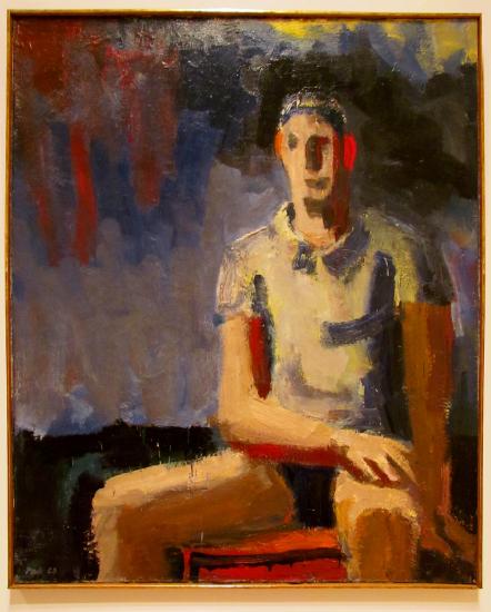 A man sitting in a chair painted in multiple colors