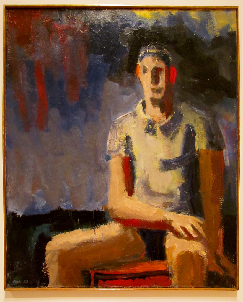 A man sitting in a chair painted in multiple colors