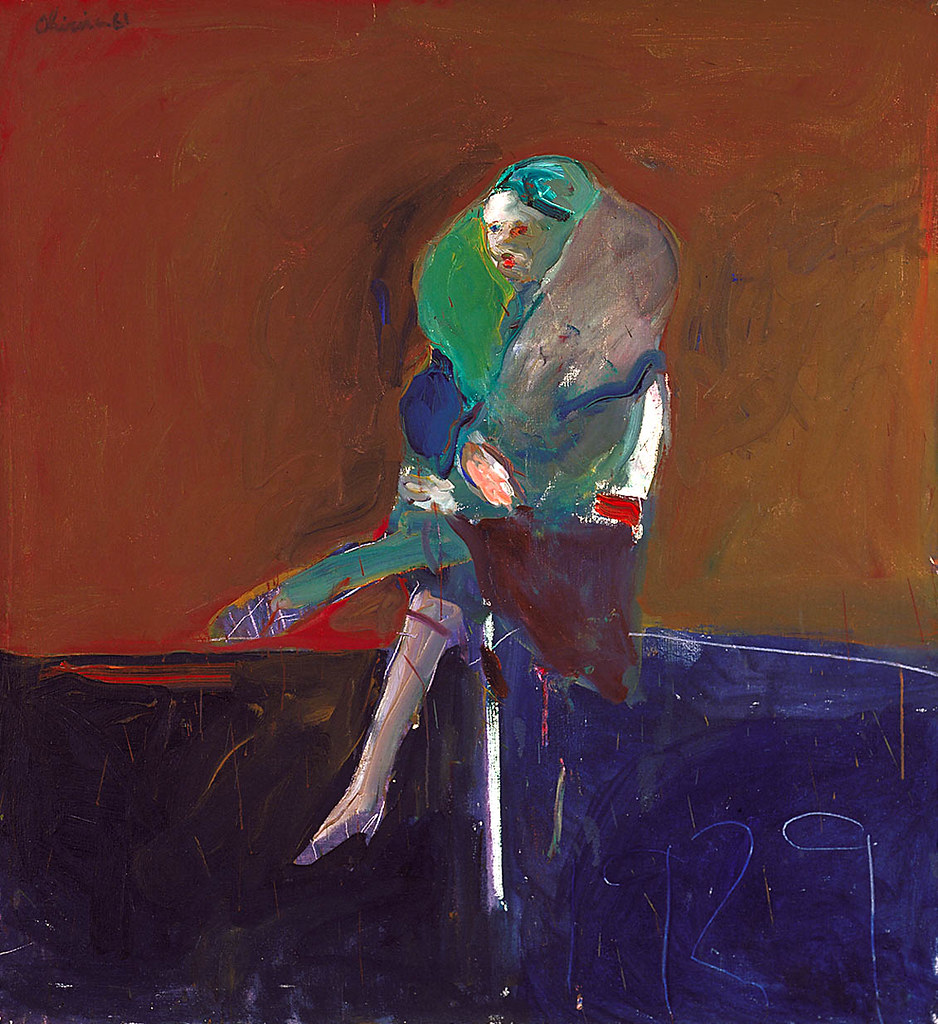 A woman sitting in a chair with a multi color outfit