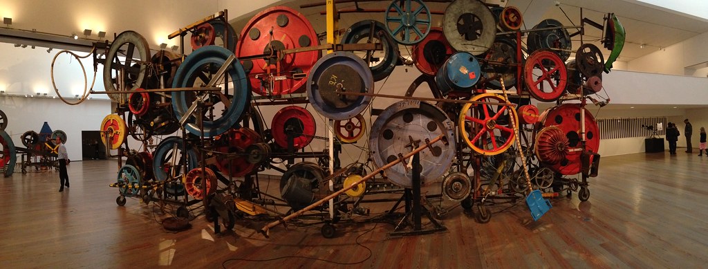 A large colorful sculpture made of recycled parts