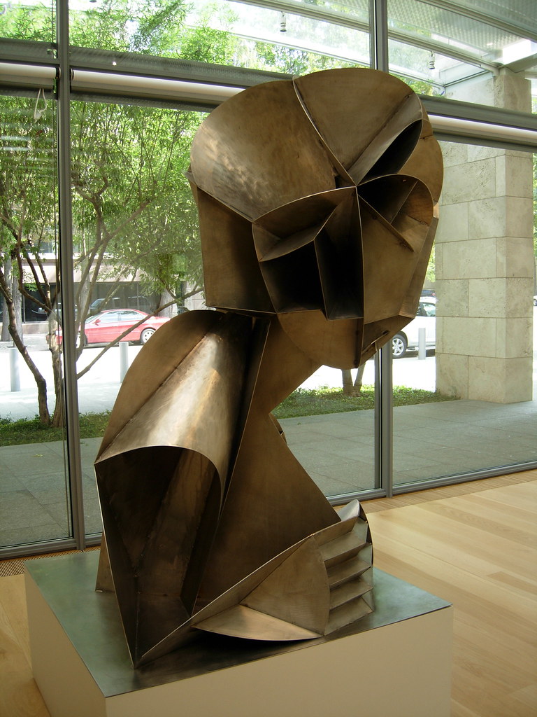 A metal sculpture bust of a head