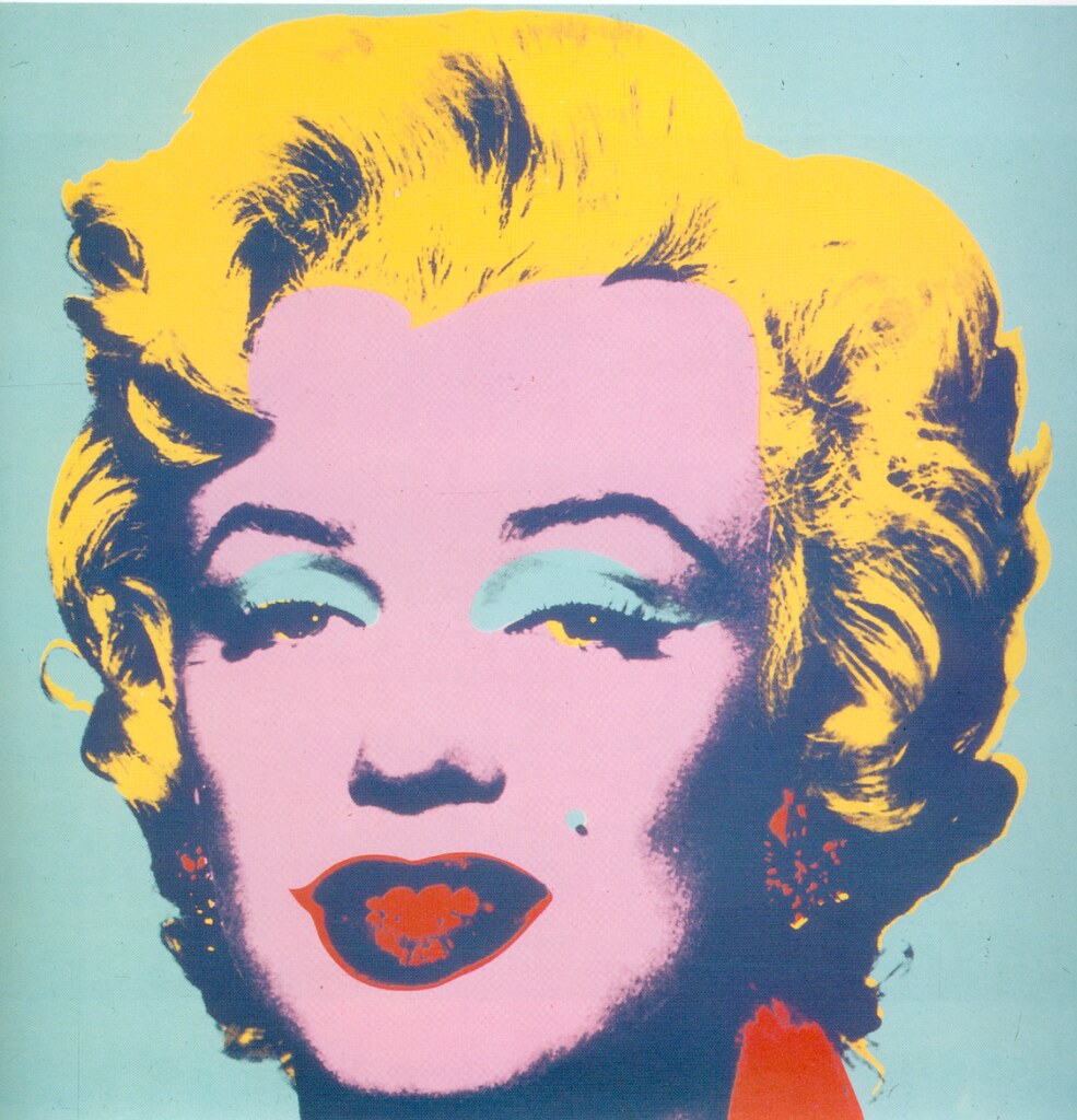 A woman with a pink face, yellow hair and red lips