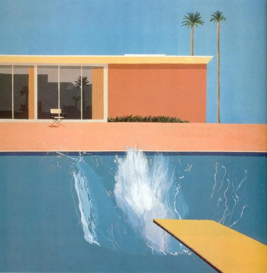 A person who just dove into a blue pool off a yellow board with a splash of water against a house