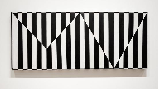 A black and white striped board on a wall