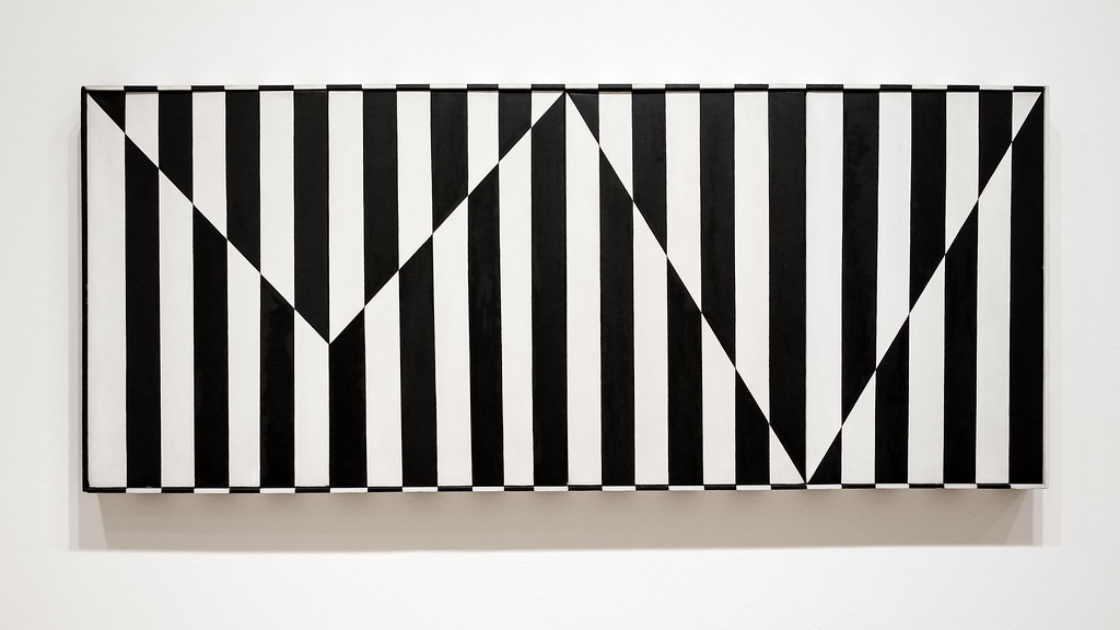 A black and white striped board on a wall