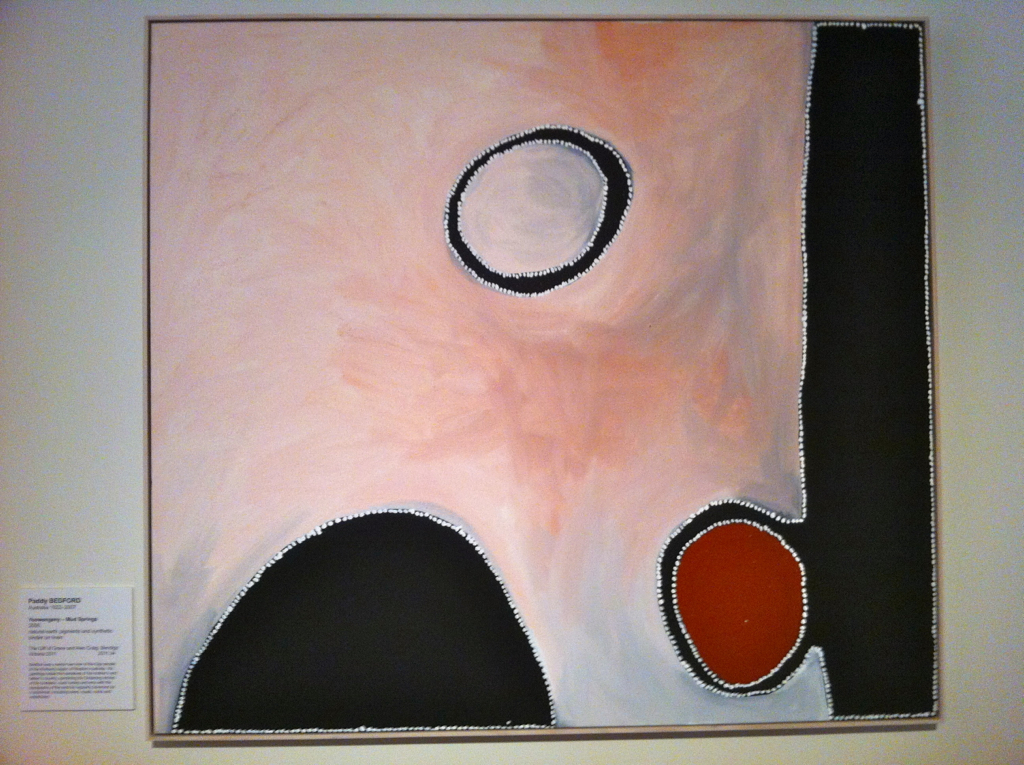 a black background with large white shapes and red circle