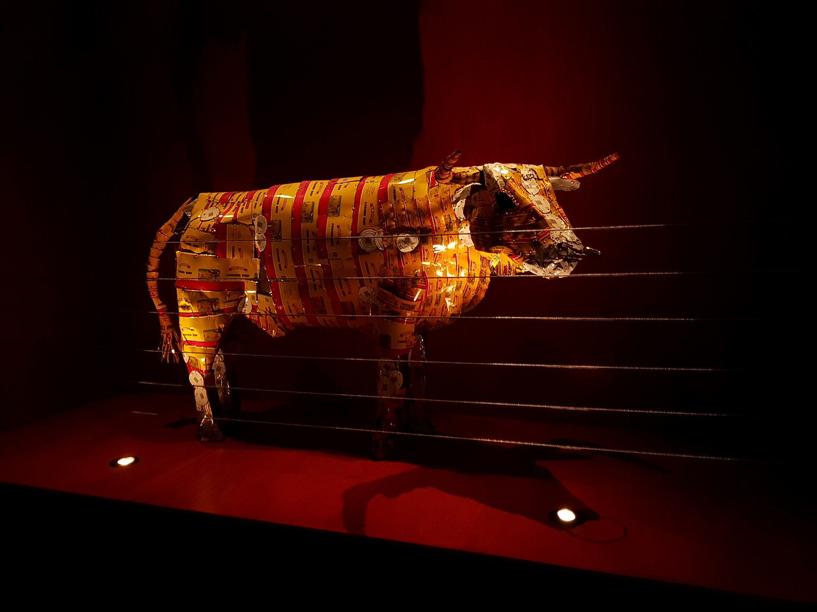 A cow made out of corn beef cans
