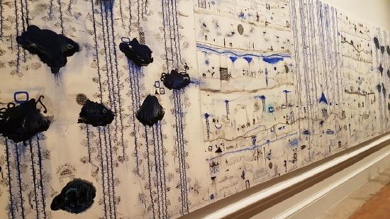 a large painting on a white background with shapes in blue and black