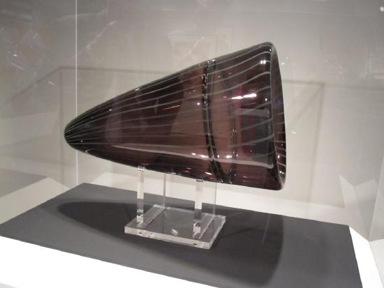 a glass blown vessel in deep browns