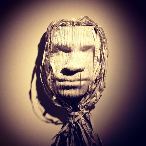 a mask made to represent a man made from shredded paper
