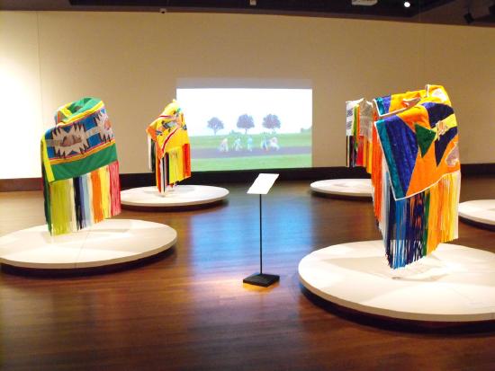 Bright colorful shawls displayed in a musuem