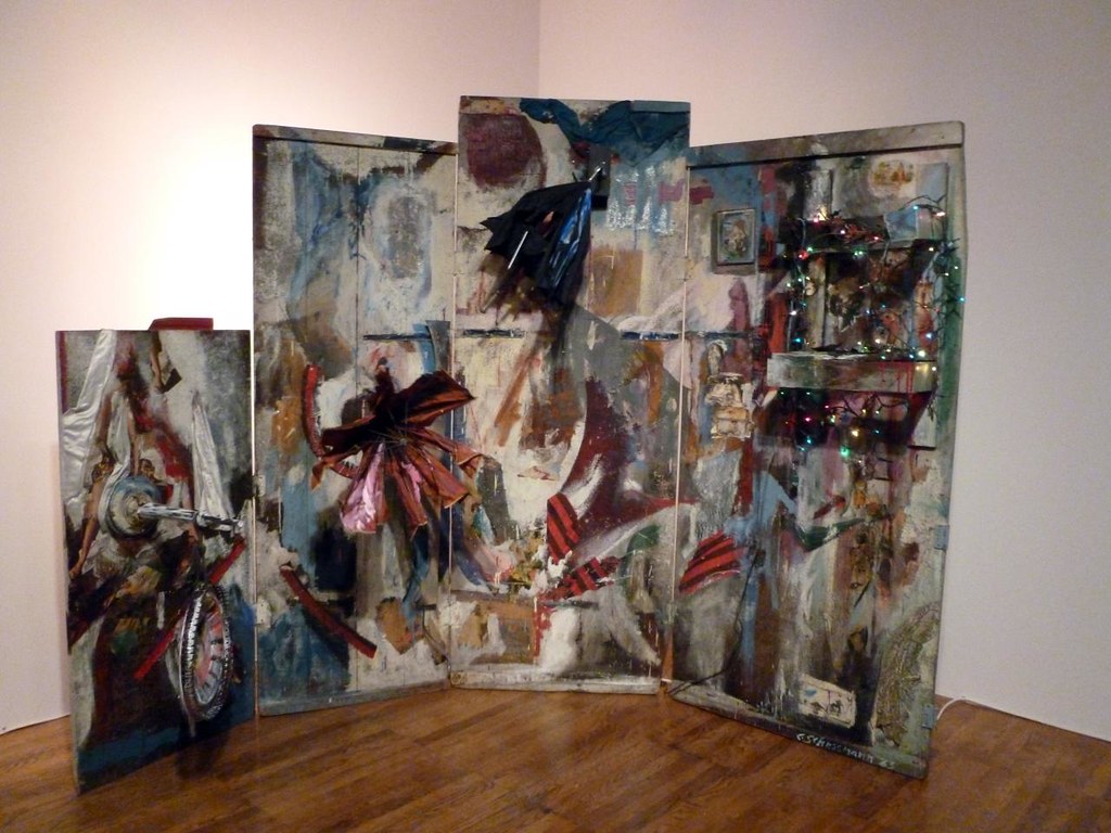 several panels painted with multiple colors with some attachments of fans and other pieces of found objects