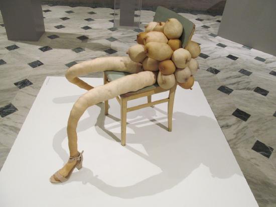 Nylons stuffed and legs positioned on a chair with more stuffed nylons in the shape of women's breasts
