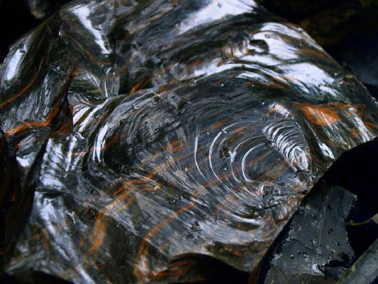 a glistening rock that is black and brown