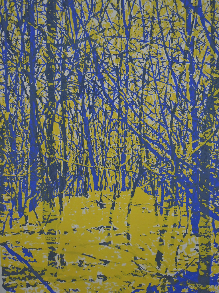 a print of trees that are blue and yellow 
