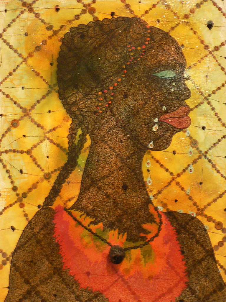 a portrait of a woman in an orange shirt against a yellow diamond shaped background