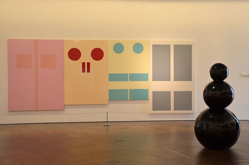Four doors hanging on the wall with shapes and colors