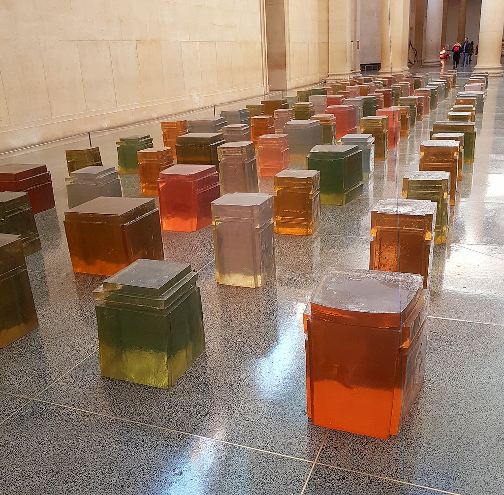 colored boxes arranged in a grid on a floor