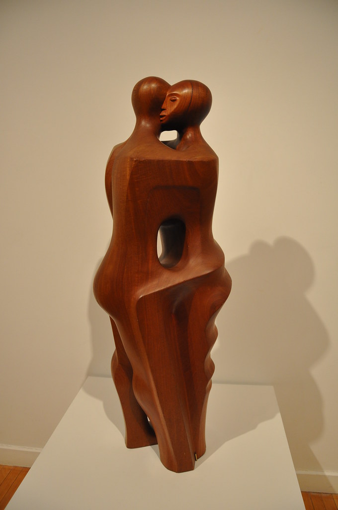 two embraced people carved from wood