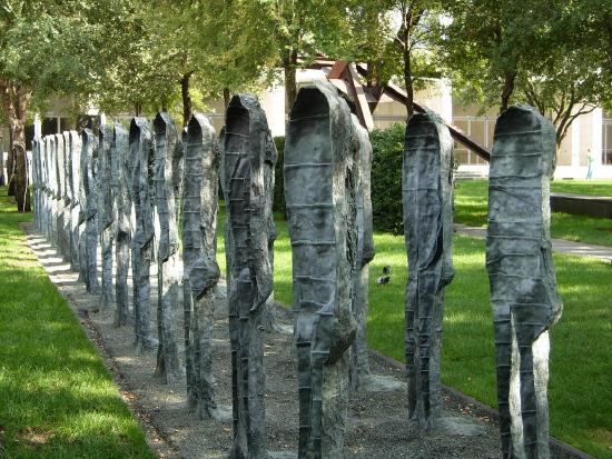 large metal sculptures that look like spoons in a park
