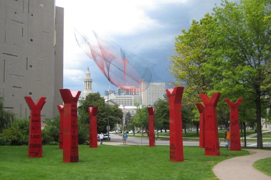 several upright red "Y"'s in grass with text on them