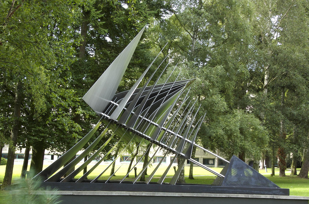 a metal sculpture of many sheets of metal cut into triangles