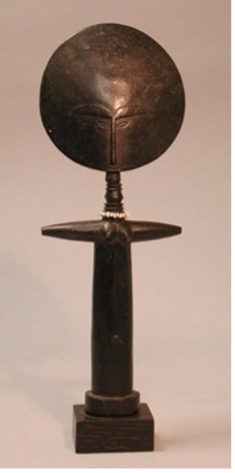 small metal sculpture of a person with oversized head 