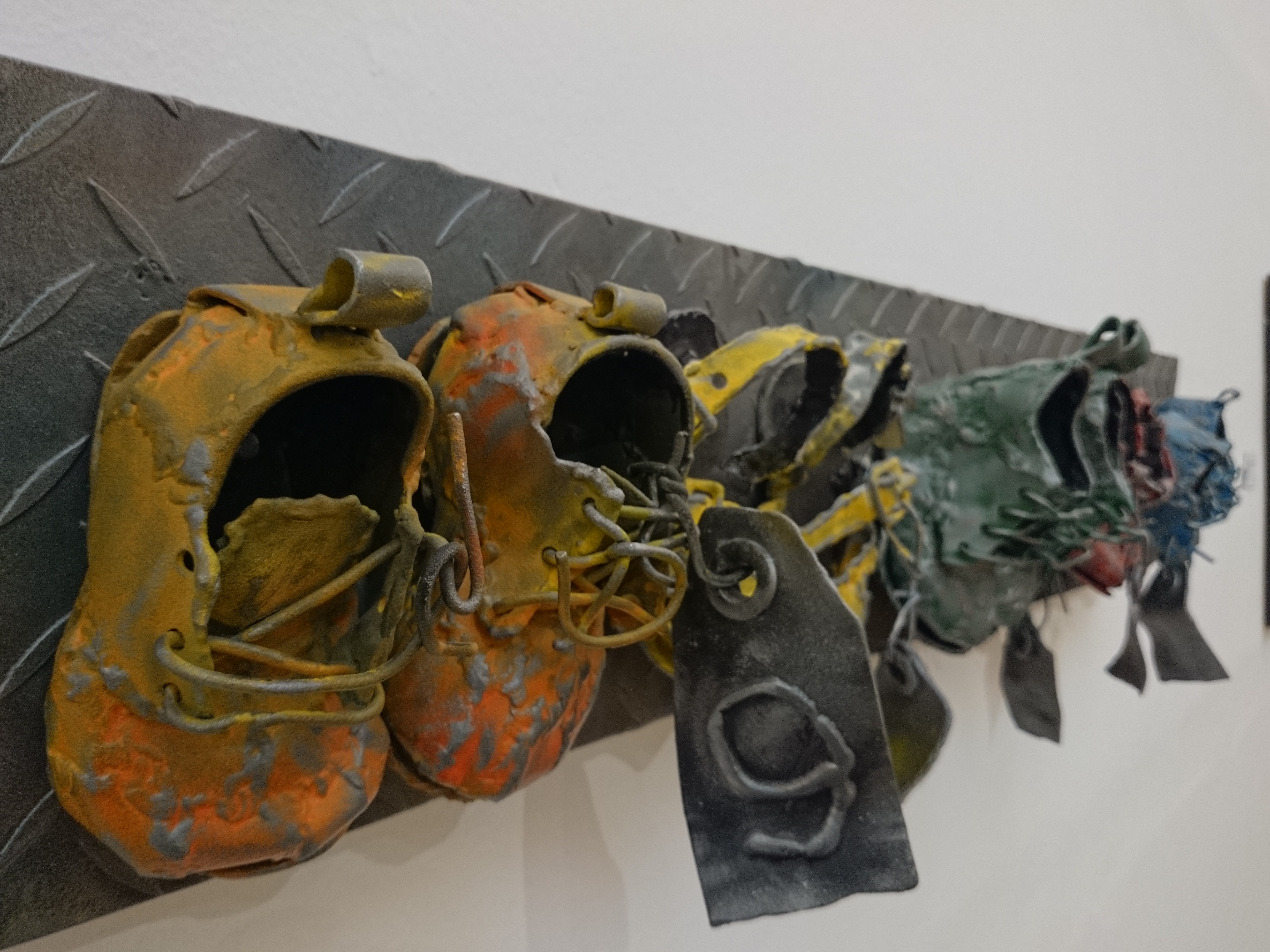 colored baby shoes on a piece of metal