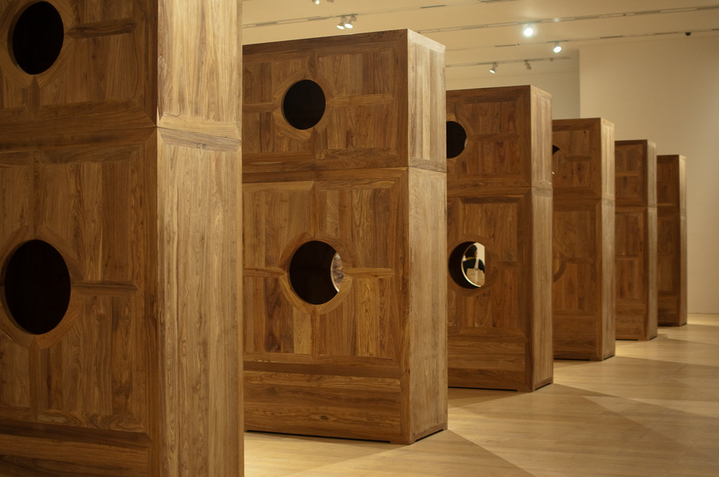stacked wooden boxes with large holes 