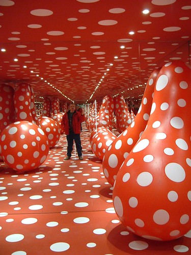 a large room painted red with thousands of white polka dots