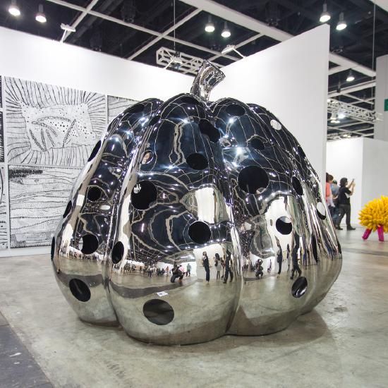 large metal pumpkin with holes cut out reflecting the room