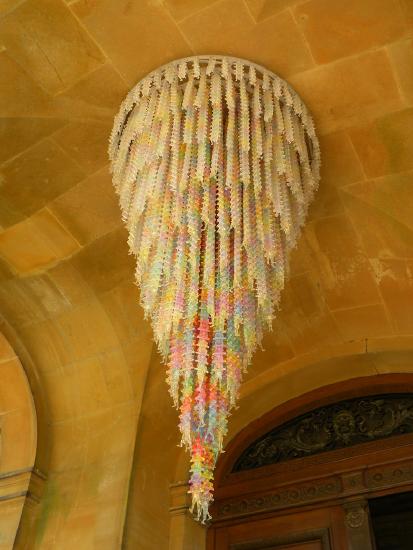 a chandiler in multi colors hanging from the ceiling 