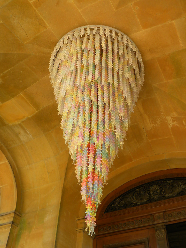 a chandiler in multi colors hanging from the ceiling 