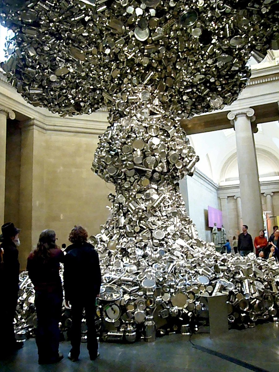 a lot of pieces of metal made into a large sculpture that looks like a bomb went off
