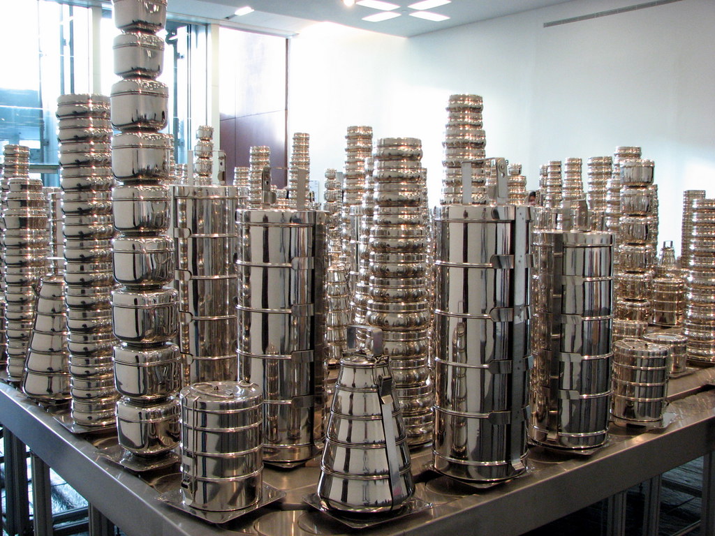 silver pots stacked to replicate a city scape