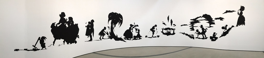 a black and white cutout with people in different positions
