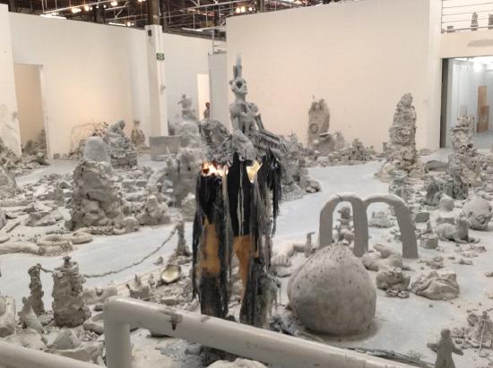 white clay figures, unidentified objects and slabs of clay in a scattered area