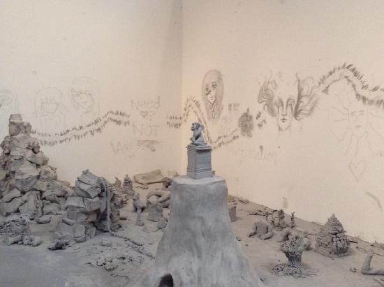 white clay figures, unidentified objects and slabs of clay in a scattered area
