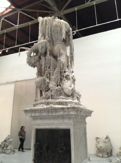 a statue of people3 with ribbons of clay up on a pedestal