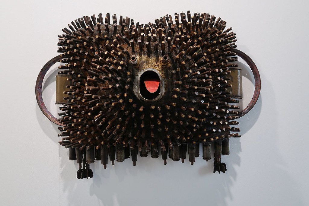 a porcupine looking animal made out of used shells from guns