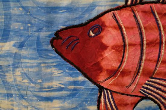 a red fish on a blue background sewn like a quilt