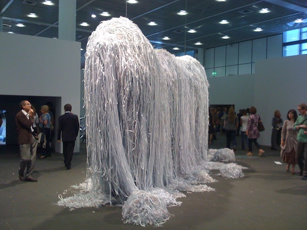 a large shape like an elephant covered with plastic ropes