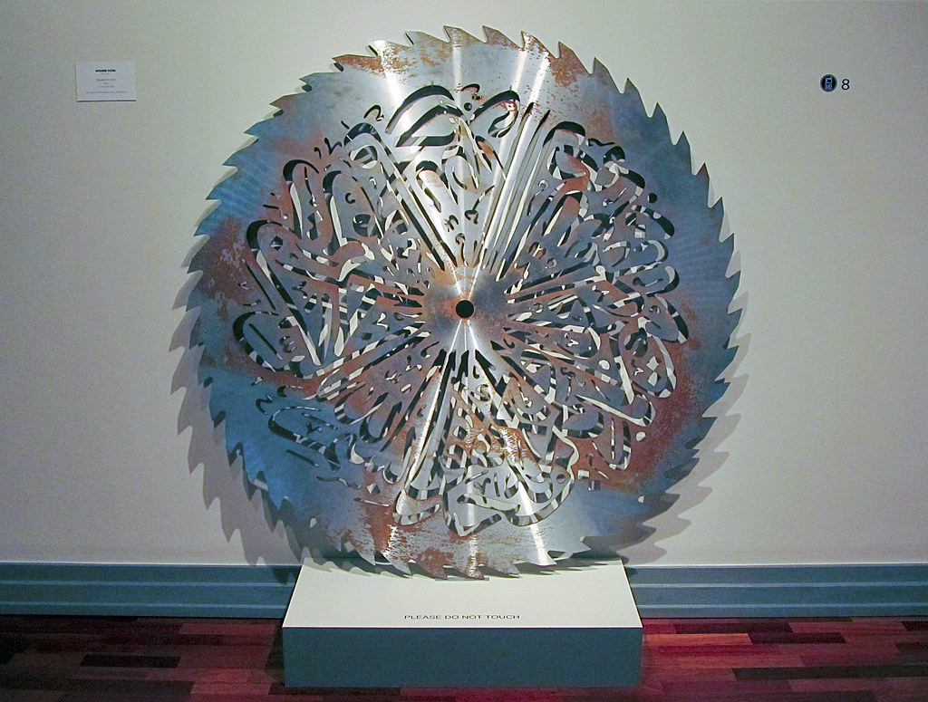 a large circular saw blade with intricate lines carved into the steel