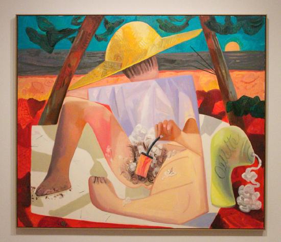 a nude woman on a beach shaving herself