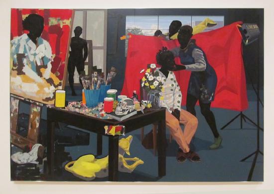 an artist studio with a canvas, a model, and paints