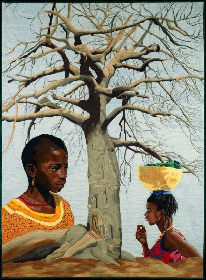 two woman standing next to a tree wearing bright colored clothing