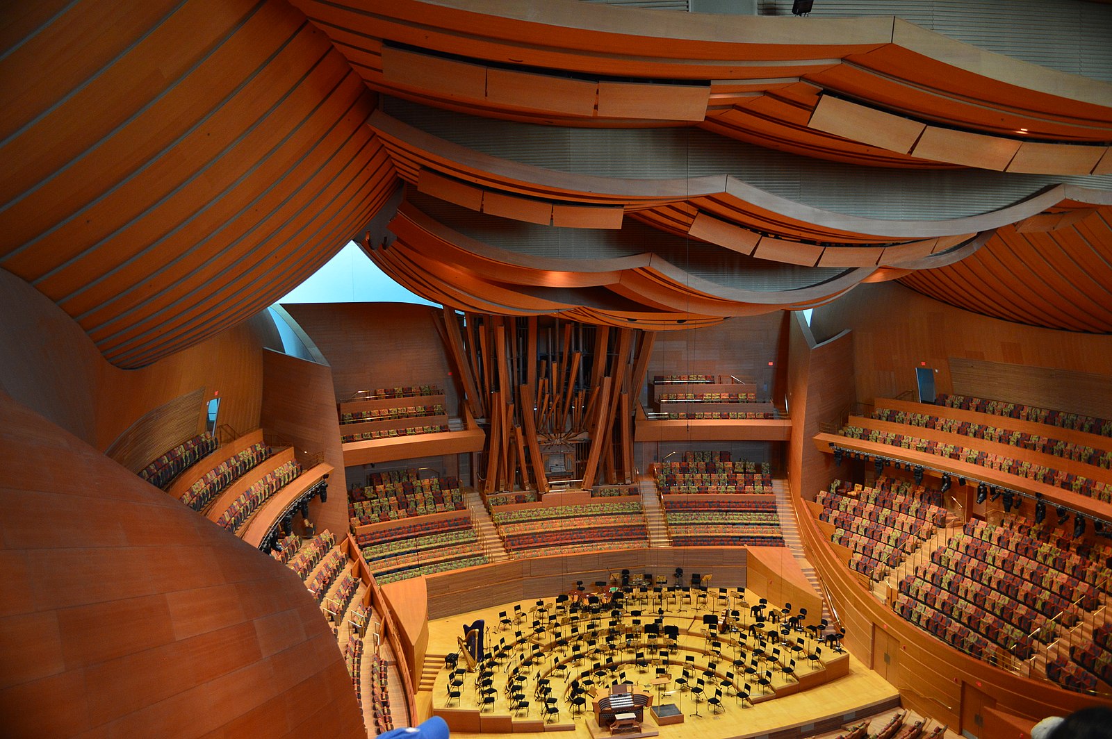 inside a concert hall with seats and wooden walls