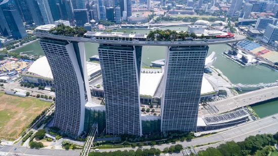 Three tall buildings with a ship like structure with an infinity pool on top
