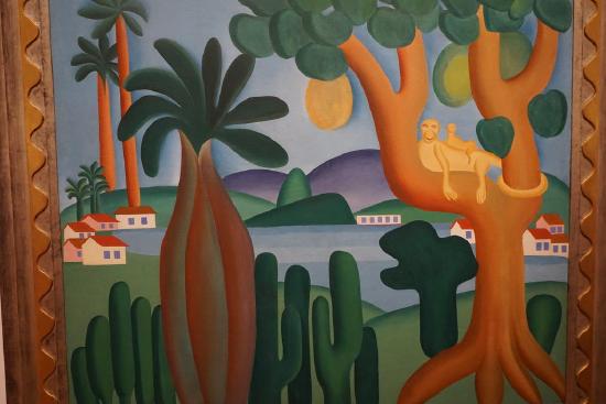 tropical scene with trees, water and mountains