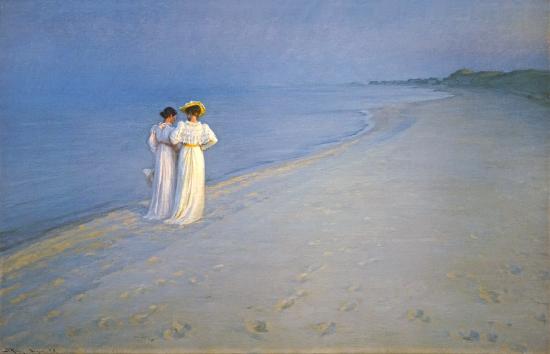 Two women walking on a beach
